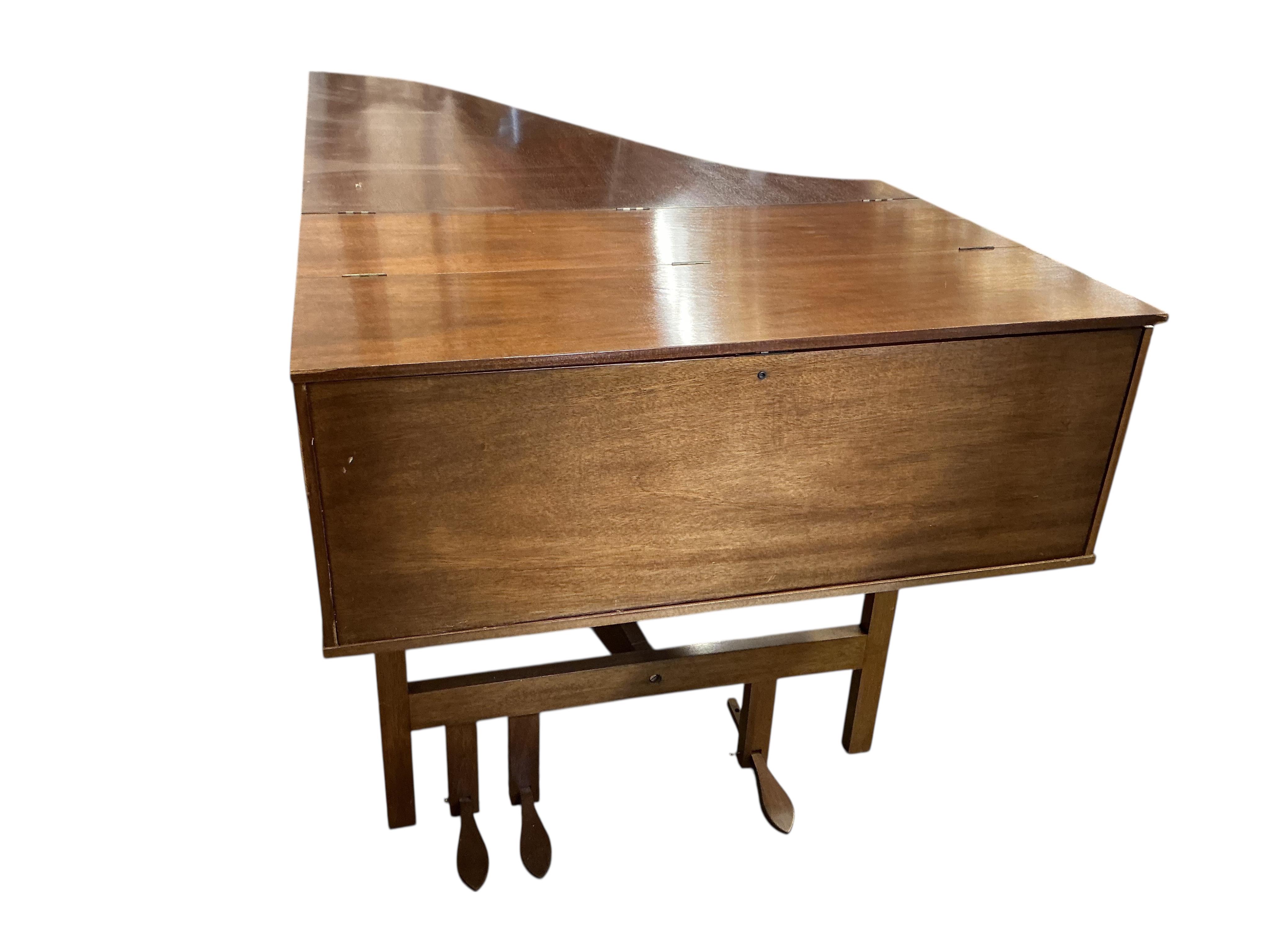 A 1960s two manual harpsichord by John Morley, 61 note compass on each manual with coupler, one stop and three pedals, in mahogany veneer, signed to the soundboard and above the manuals, serial number 1052, length 207cm